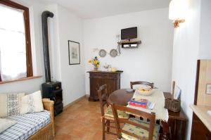 a living room with a table and a couch at Colle sul Lago in Castiglione del Lago