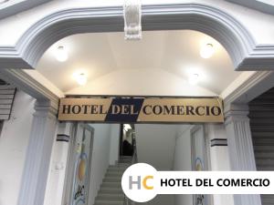 a hotel del cantico sign hanging from a building at Hotel del Comercio in Villavicencio
