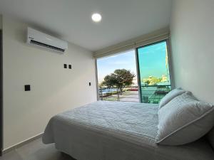 a bedroom with a bed and a large window at Depa Nuevo Acapulco Diamante in Acapulco +30 photos