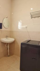 a bathroom with a sink and a mirror on the wall at HSR layout Abode 2 in Bangalore