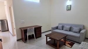 a living room with a couch and a table at HSR layout Abode 2 in Bangalore