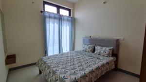 a bedroom with a bed and a window at HSR layout Abode 2 in Bangalore