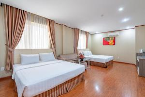 Postel nebo postele na pokoji v ubytování La Palma - Garden Saigon Hotel Phu My Hung
