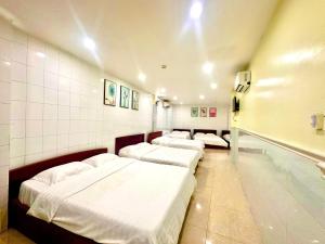 a row of beds in a hospital room at 31B Hotel - Near Ninh Kieu Wharf in Can Tho +29 photos