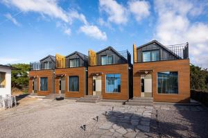 a large house with a lot of windows at Neul Olle Stay in Jeju