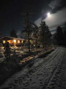 a person riding a bike in the snow at night at Charming Log Cabin With Modern Luxury in Jordet