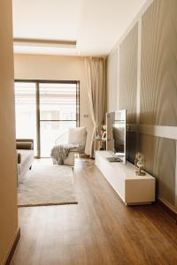a living room with a couch and a tv at Lanna Fusion in Hang Dong