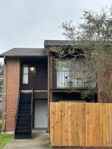 a house with a wooden fence and a staircase at Perkins Cove in Baton Rouge