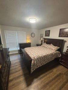 a bedroom with a bed and a clock on the wall at Perkins Cove in Baton Rouge