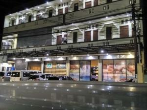 a fast food restaurant with cars parked in front of it at deKOST Madiun in Madiun