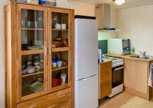a kitchen with a white refrigerator and a microwave at Unique Setting And Silence On Private Island in Byglandsfjord +7 photos