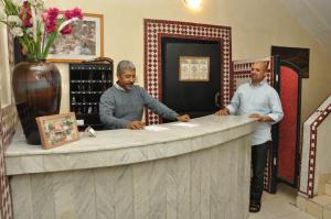 two men standing at a counter in a wine shop at Hotel Boustane in Casablanca