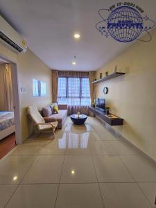 a living room with a couch and a table at I-City I-Suite Two Room Free Park BASRI PROPERTI in Shah Alam