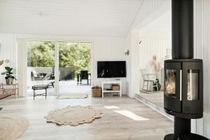 un salon avec une cheminée et une télévision dans l'établissement Classic Seaside Hotel Feel In Ringkøbing Fjord, à Hemmet