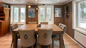 a dining room with a wooden table and chairs at Charming Farm From 1600S In Stunning Surroundings in Treungen +22 photos