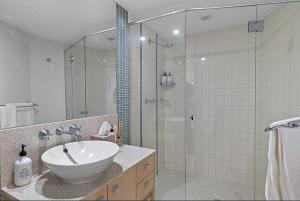 a bathroom with a sink and a glass shower at Sebel Apartments - Beautiful 2 Bedroom With Private Rooftop - CHM in Maroochydore +5 photos