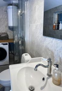 a bathroom with a sink and a toilet at Bright, Airy, And Blissful Idyllic Holiday Home in Norrtälje