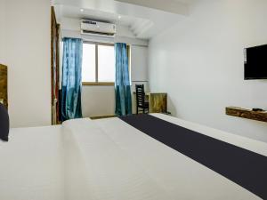 Postel nebo postele na pokoji v ubytování Super Townhouse Madgaon