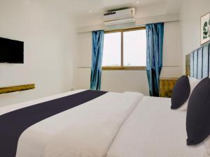Postel nebo postele na pokoji v ubytování Super Townhouse Madgaon