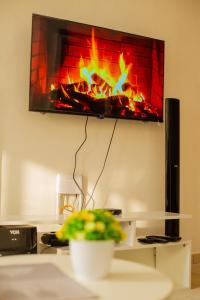a living room with a fire in a fireplace at Classic Studio Bamburi in Mombasa