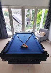 a large blue pool table in a living room at Olivia Estate by Villas Direct Bali in Seminyak