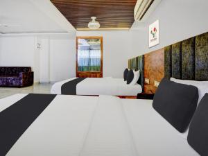 Postel nebo postele na pokoji v ubytování Super Townhouse Madgaon
