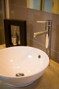 a white sink with a faucet on a counter at Gallery Apartments in Warrnambool