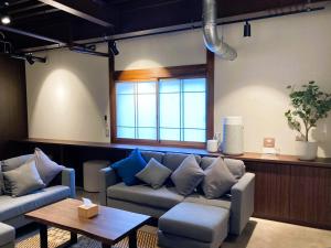 a living room with a couch and a table at Misono no Oyado - RO 美園のおやど - ろ #IO2 in Wakayama