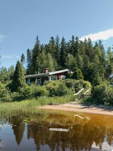 a house on the shore of a body of water at Lake View Holiday Home With Natural Charm in Storfors