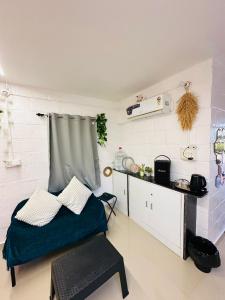 a bedroom with a bed and a table in it at The greenwood Igoor in Dāvangere