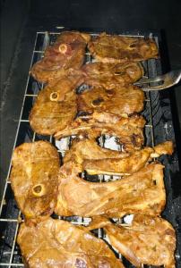 a bunch of food cooking on a grill at Jayla Homestay in Maun