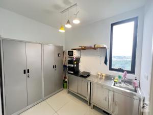 a kitchen with stainless steel cabinets and a window at Retreat Stay Icon City PJ up to 5 paxs in Petaling Jaya