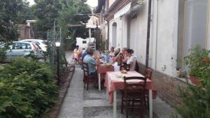 a group of people sitting at tables on a patio at La Chicca B&B in Cassine