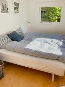 a large bed in a room with a window at Cosy, Undisturbed Sanctuary Away From The City in Nykøbing Sjælland