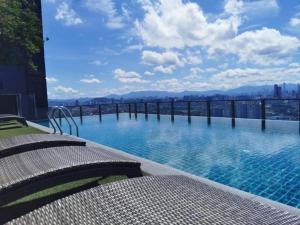 a swimming pool with a view of the city at Retreat Stay Icon City PJ up to 5 paxs in Petaling Jaya