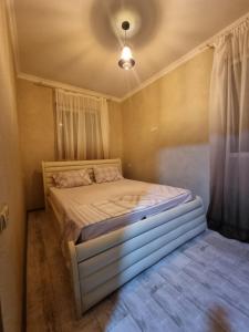 a small bedroom with a bed in a room at ALEXS house in Sadgeri