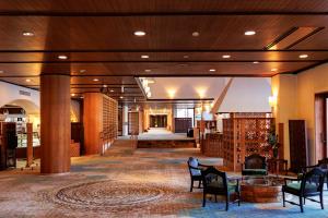 a lobby of a hotel with chairs and tables at Fuji Lake Hotel in Fujikawaguchiko