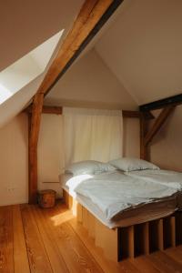 a bedroom with two beds in an attic at Design Farm House Amid Wild Uckermark Nature in Flieth