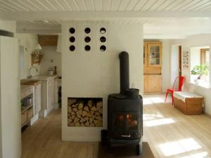 a kitchen with a wood stove in a room at Charming Farmhouse From 1875 Near Stevns Klint in Rødvig