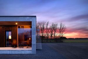 a house with a view of the sunset at Hotel Vibe In Architectural Settings in Årre +28 photos