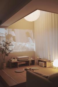 a living room with a bed and a couch at Soansosa Duplex of designer in Bucheon