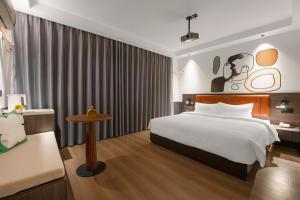 Postel nebo postele na pokoji v ubytování Mcsrh Hotel-Changsha Yuanjialing