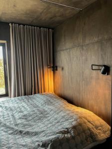a bedroom with a large bed with a window at Beach-Close Summer House With Panoramic View in Allingåbro
