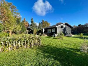 a house in a yard with a fence at Get Close To Nature And The Starry Sky in Stege