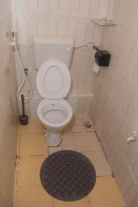 a bathroom with a white toilet in a room at Classic Studio Bamburi in Mombasa +19 photos