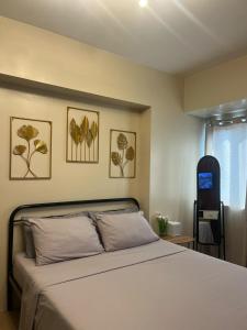 a bedroom with a bed and a blue chair at Avida Serene Staycation in Davao City +6 photos