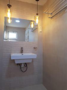 a bathroom with a sink and a mirror at ALEXS house in Sadgeri +7 photos
