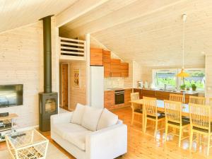 a living room with a white couch and a table at Family Cabin With Panoramic Windows By Oksrødkilen in Gressvik