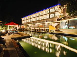 a large building with a swimming pool at night at Oh La La Koh Phangan in Haad Rin