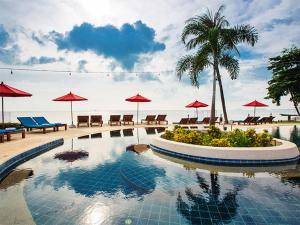 a swimming pool with umbrellas and tables and chairs at Oh La La Koh Phangan in Haad Rin
